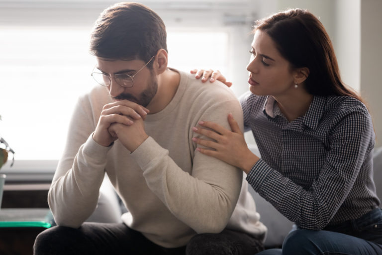 woman comforting man