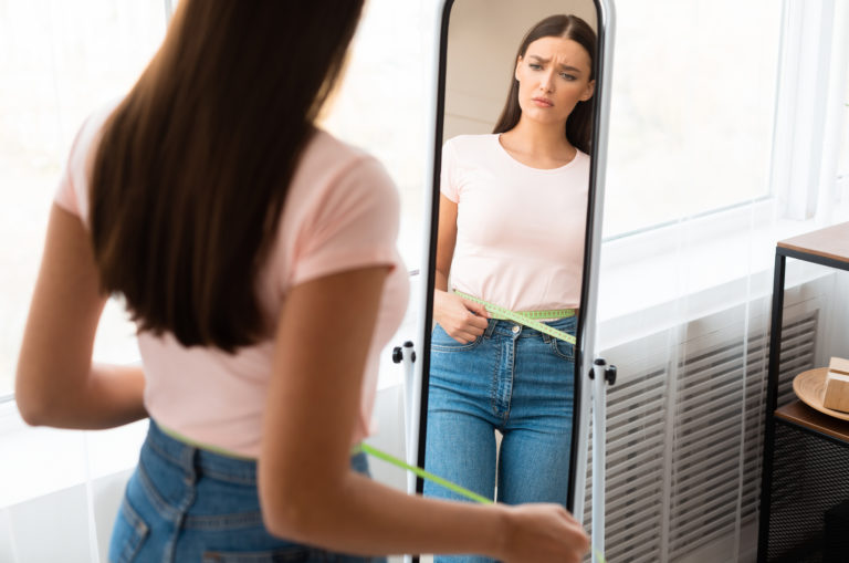 woman checking her gained weight