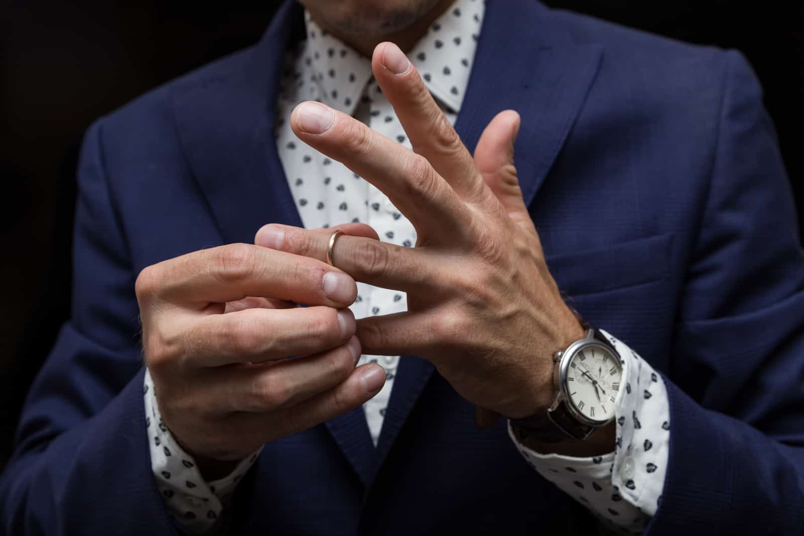 a man puts a wedding ring on his finger