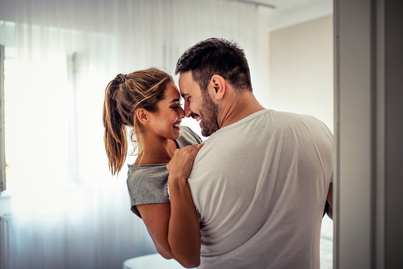 couple hugging in room