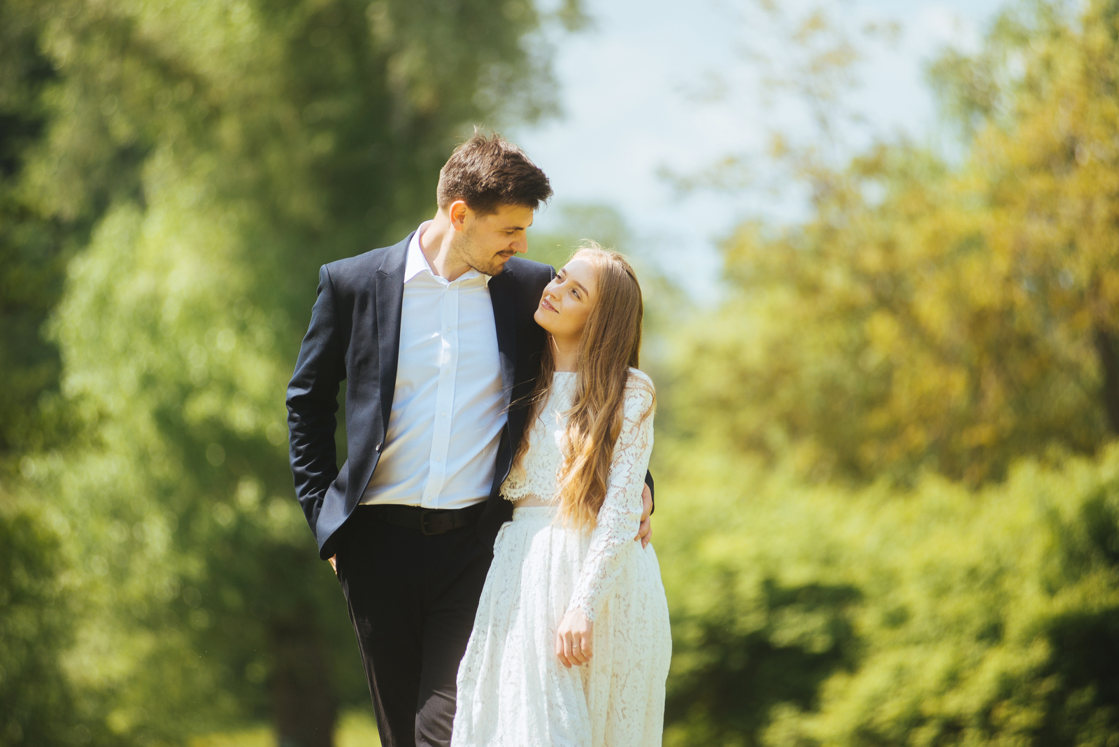 couple walking outside looking into eachother