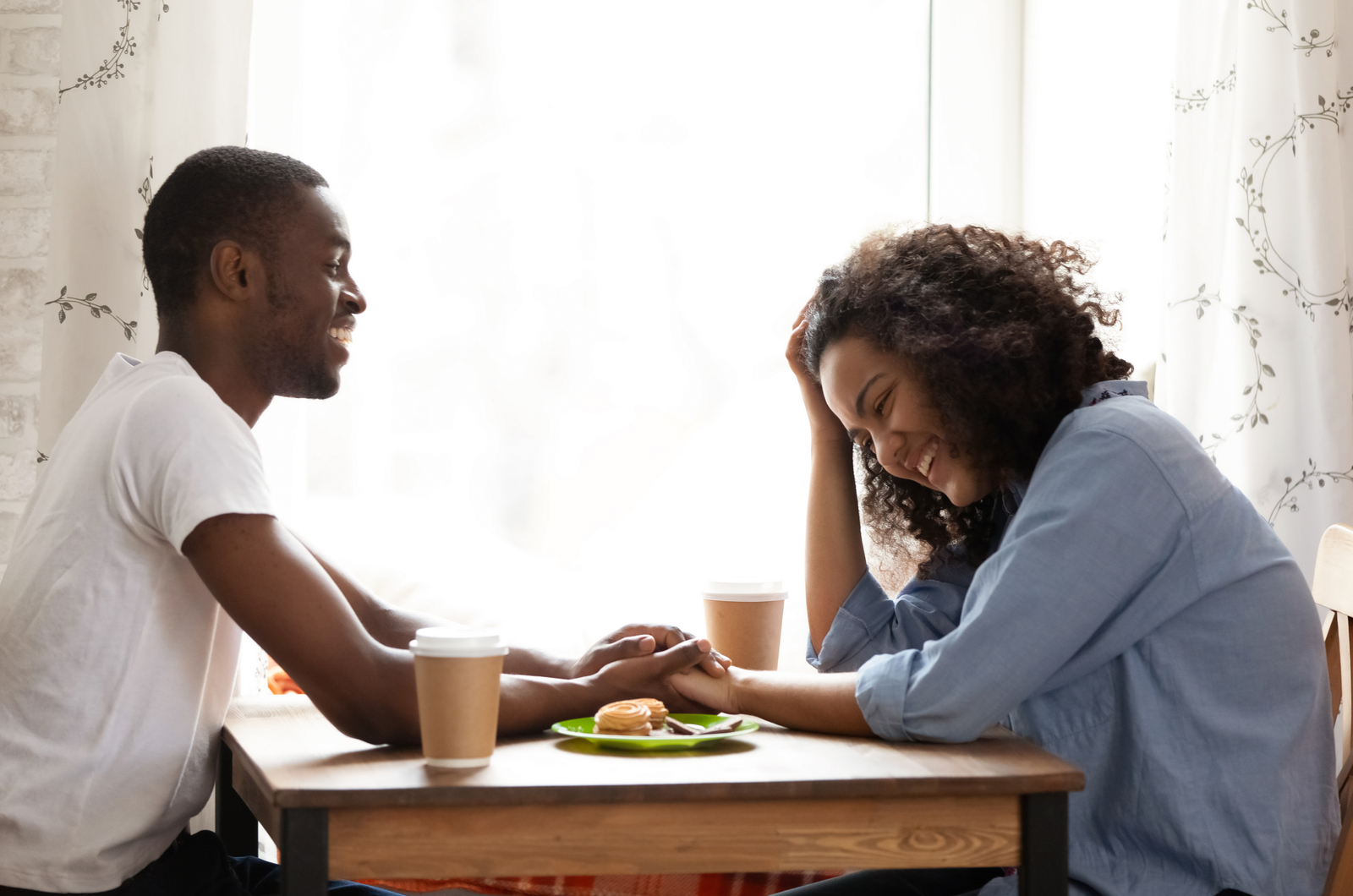 happy couple flirting while having breakfast