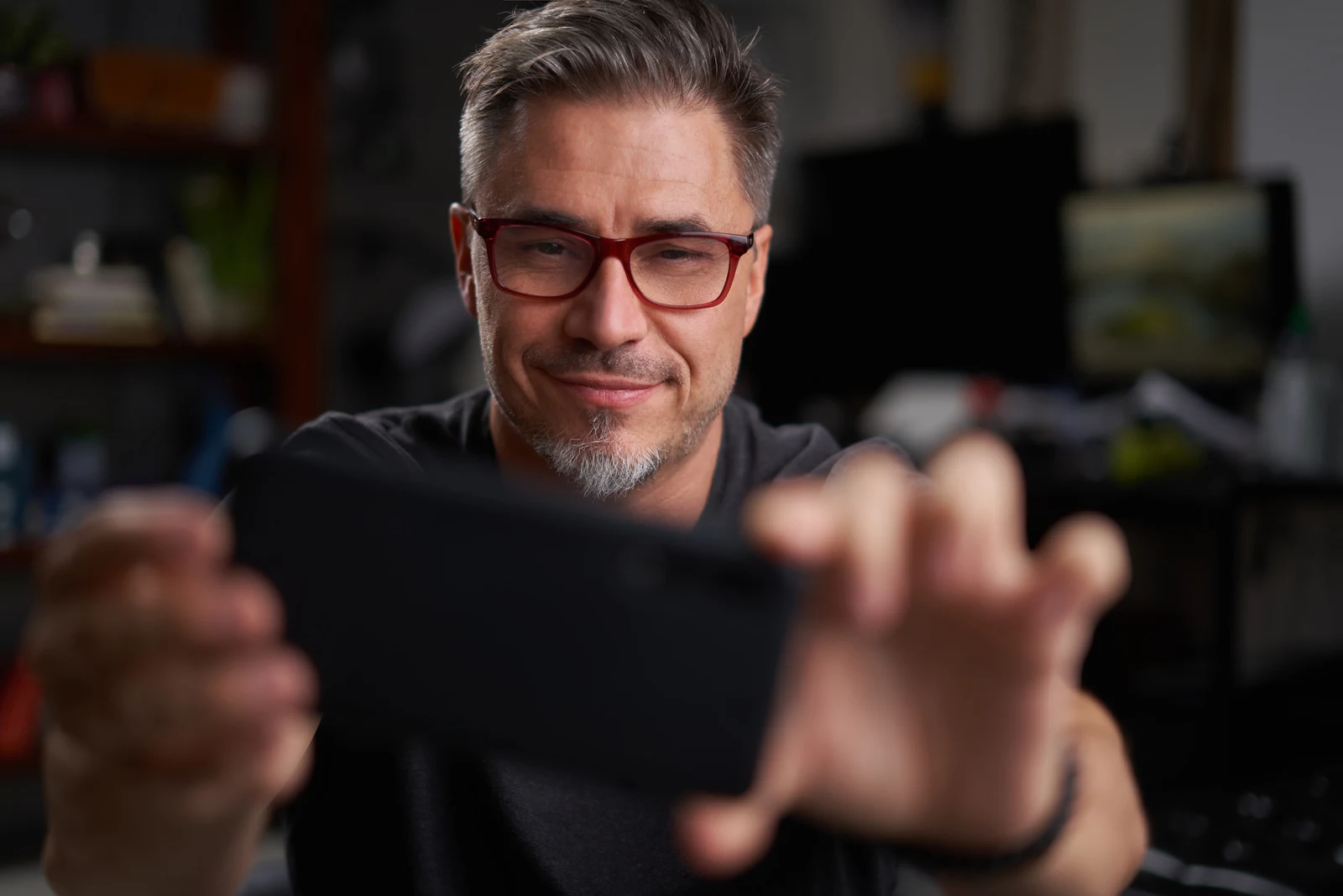 man with glasses taking selfie