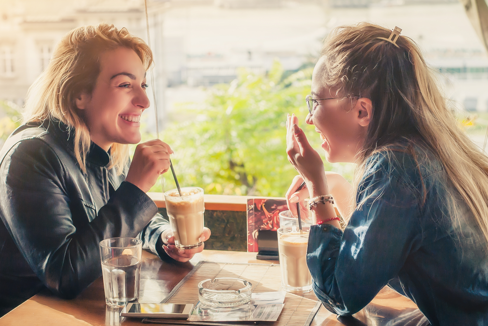 two female friends sitting in cafe