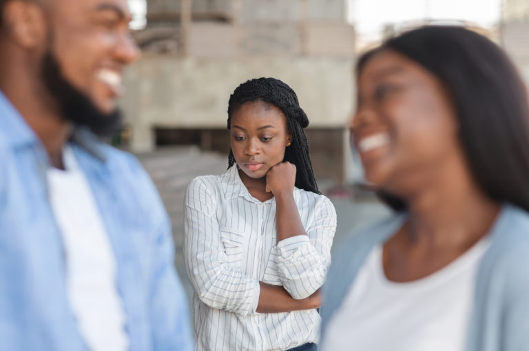 woman being ignored by her boyfriend and his female friend