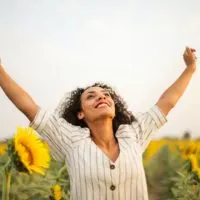 woman standing on a sunflower field
