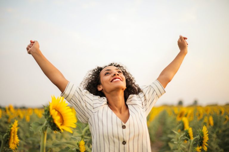 woman standing on a sunflower field
