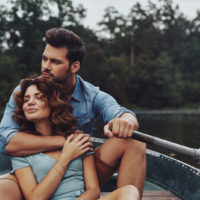a man and a woman enjoy a boat