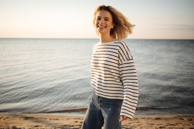 happy woman standing on the beach