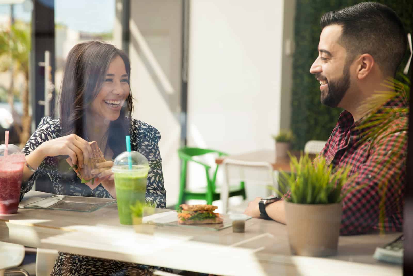 a beautiful couple is sitting in a cafe and talking