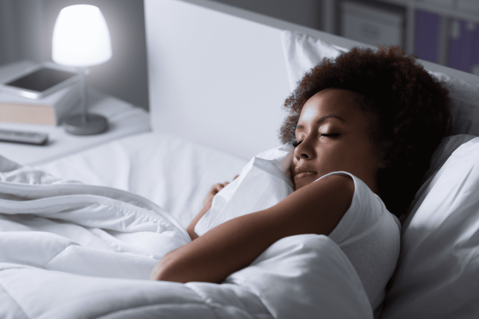 a black-skinned woman sleeps in bed