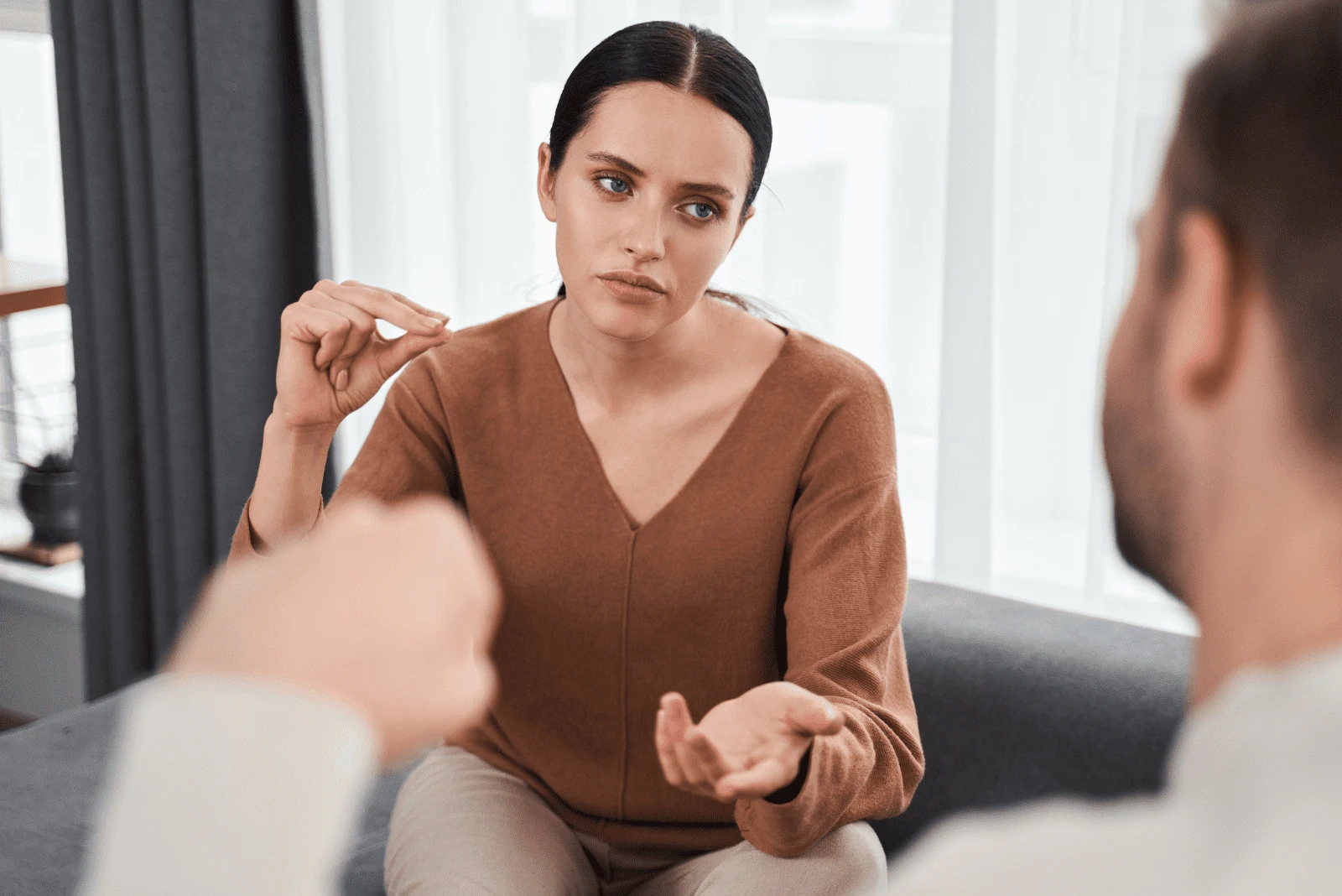 a confused woman is talking to a man