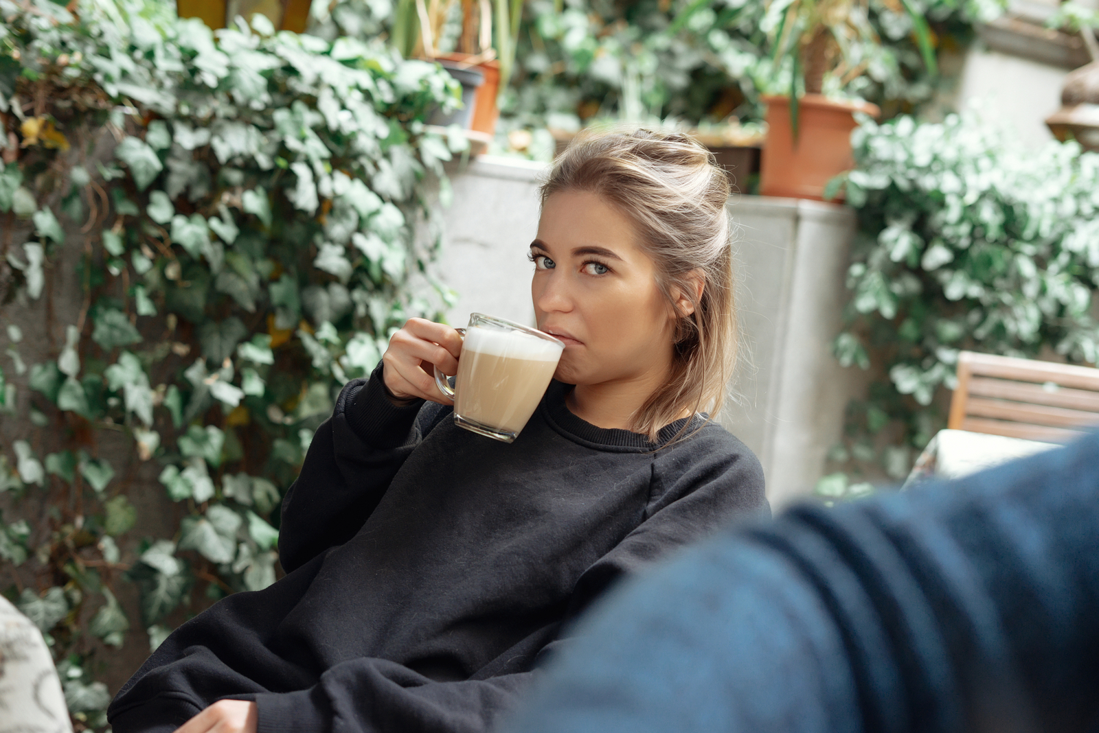 beautiful woman drinks coffee and looks away