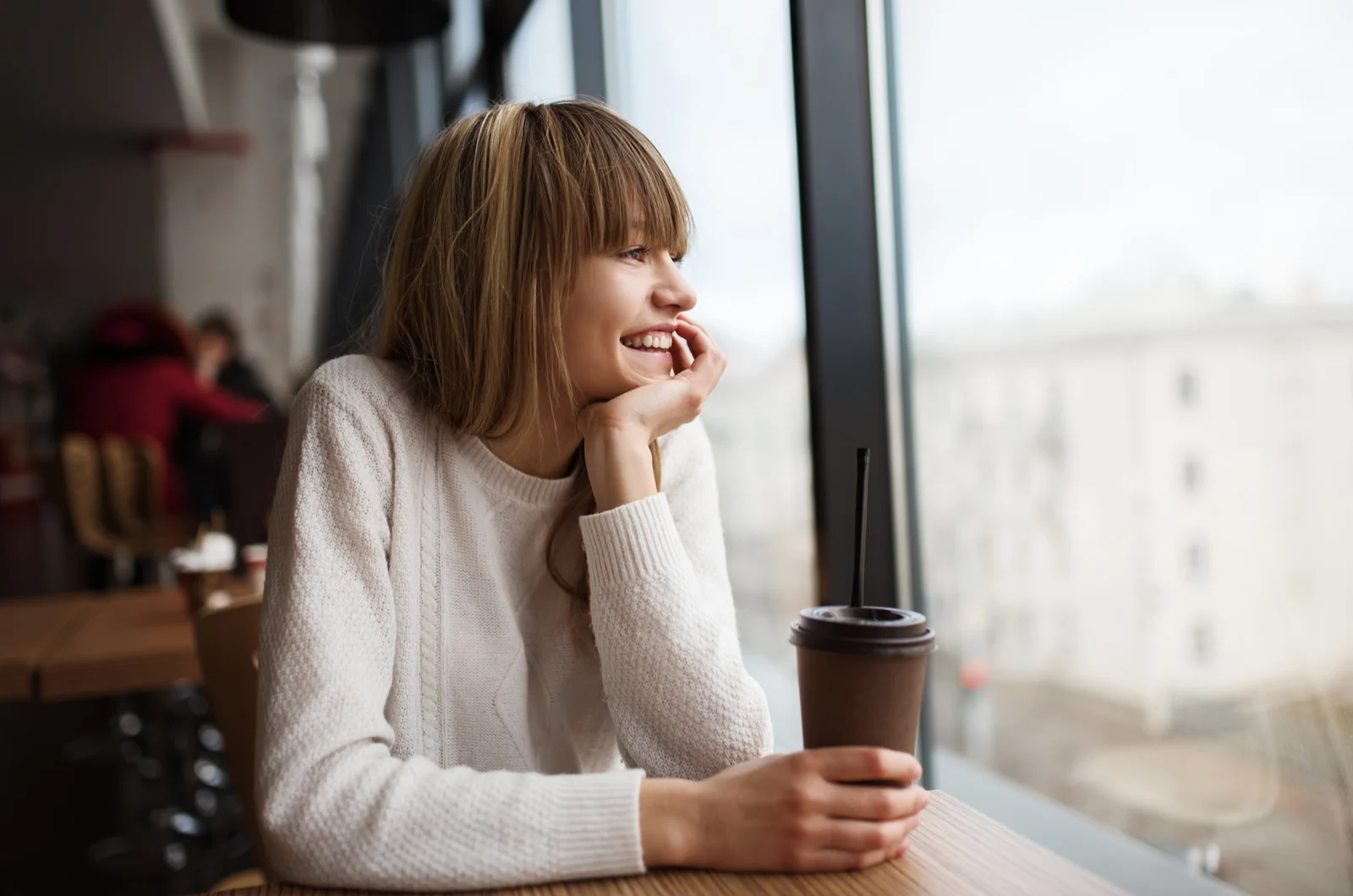 girl sitting in cafe drinking coffee