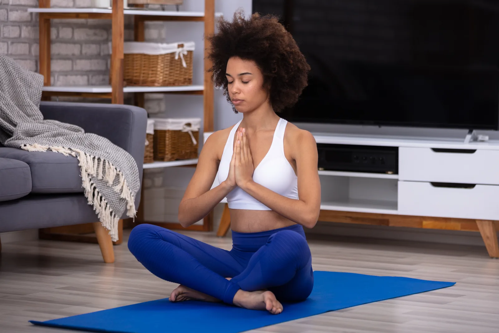 the woman is meditating at home