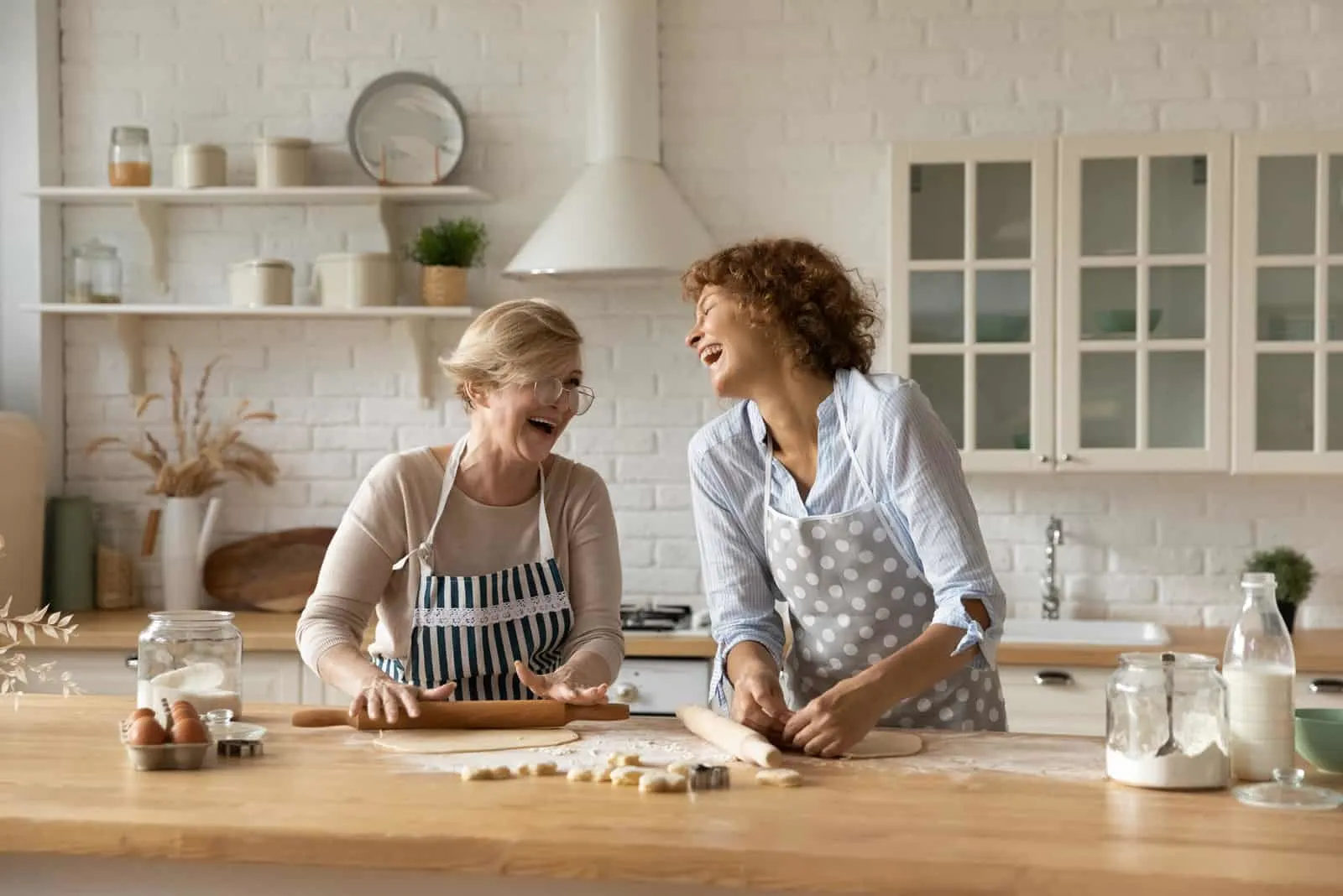 woman cooking with her mother in kitchen having fun