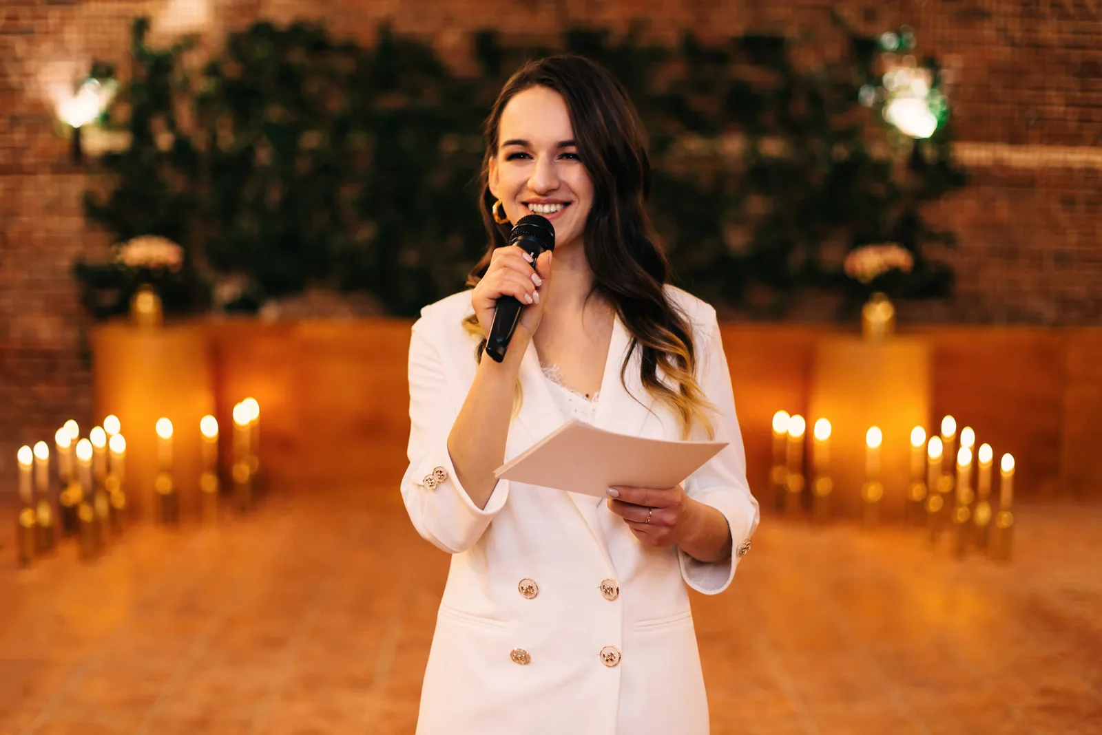 woman holds microphone and talking to wedding couple