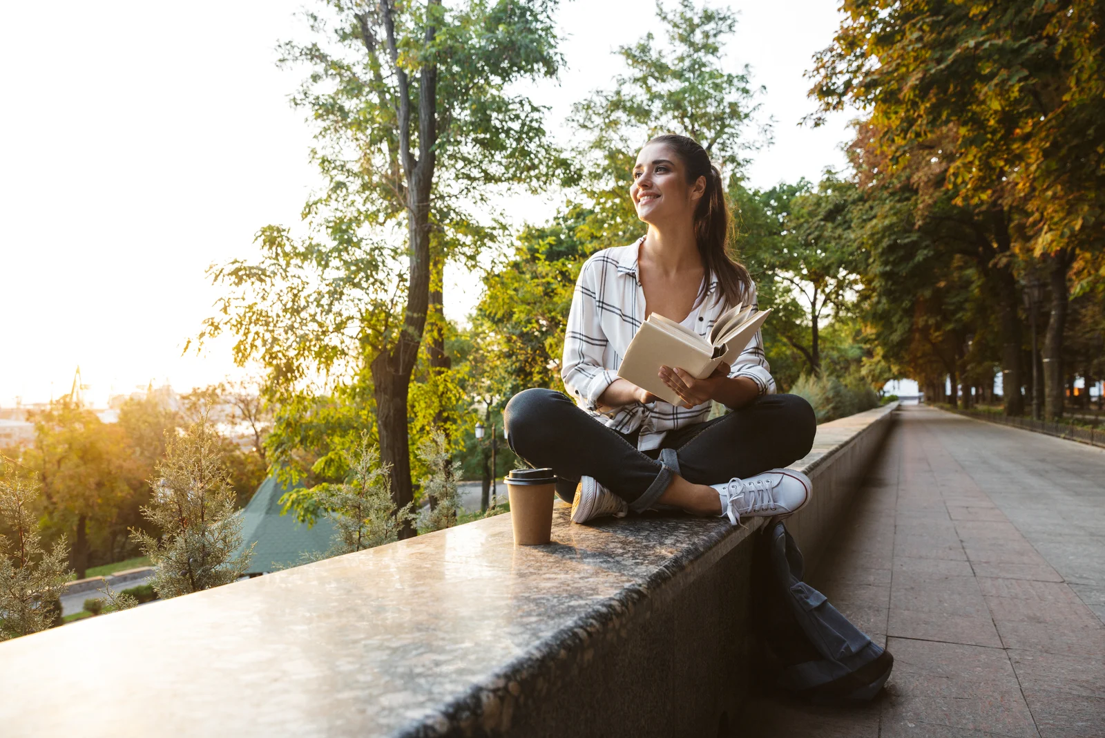 woman stting on wall in park