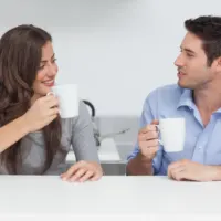 a smiling woman is talking to a man