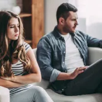 couple sitting on sofa after fight