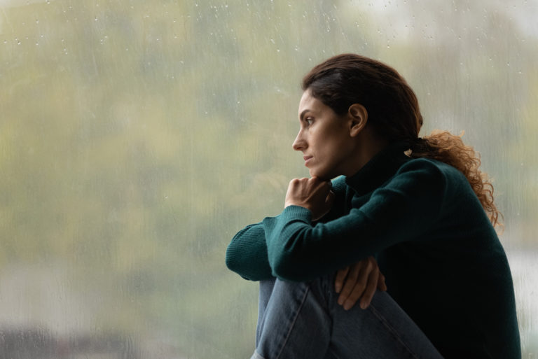 woman sitting by window