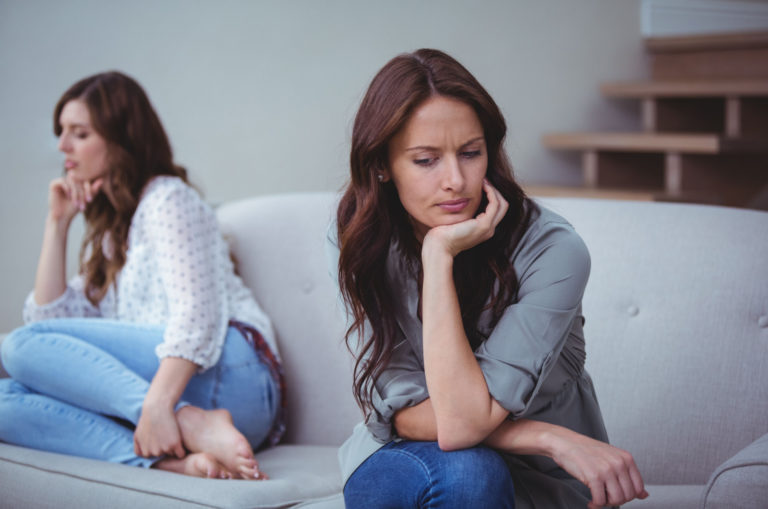 two friends ignoring each other