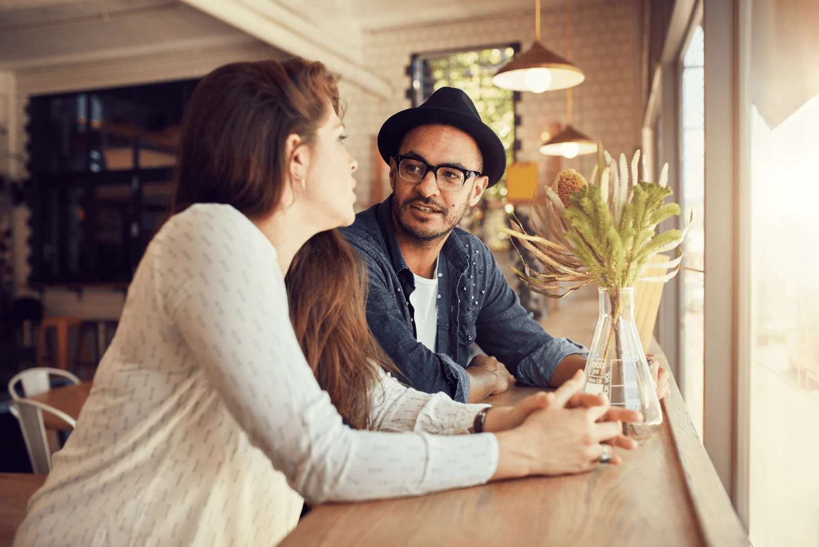 a man and a woman are sitting at the table and talking