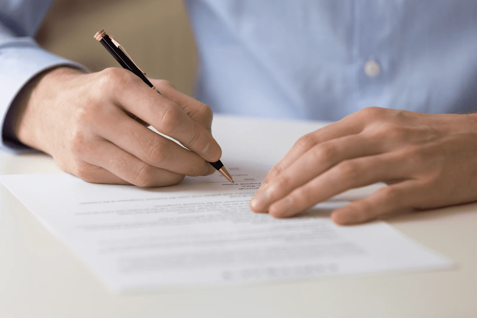 a man sits at a table and writes
