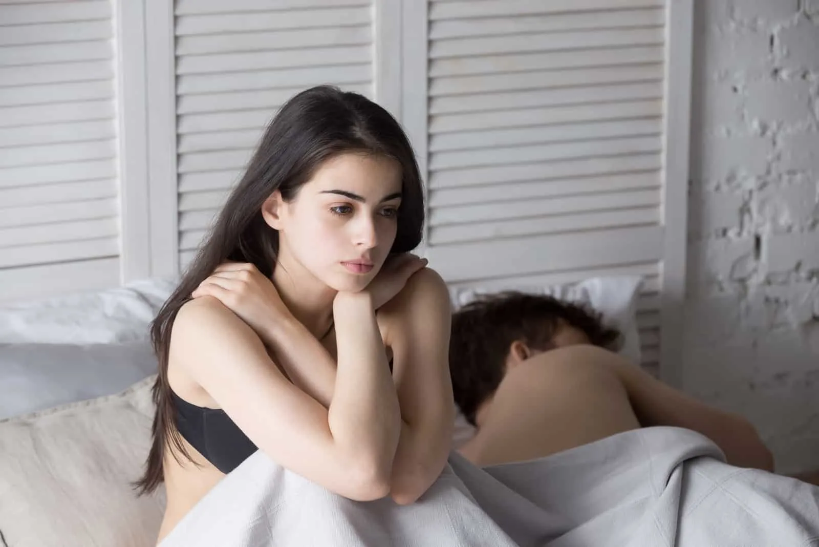 man ignoring woman in bed