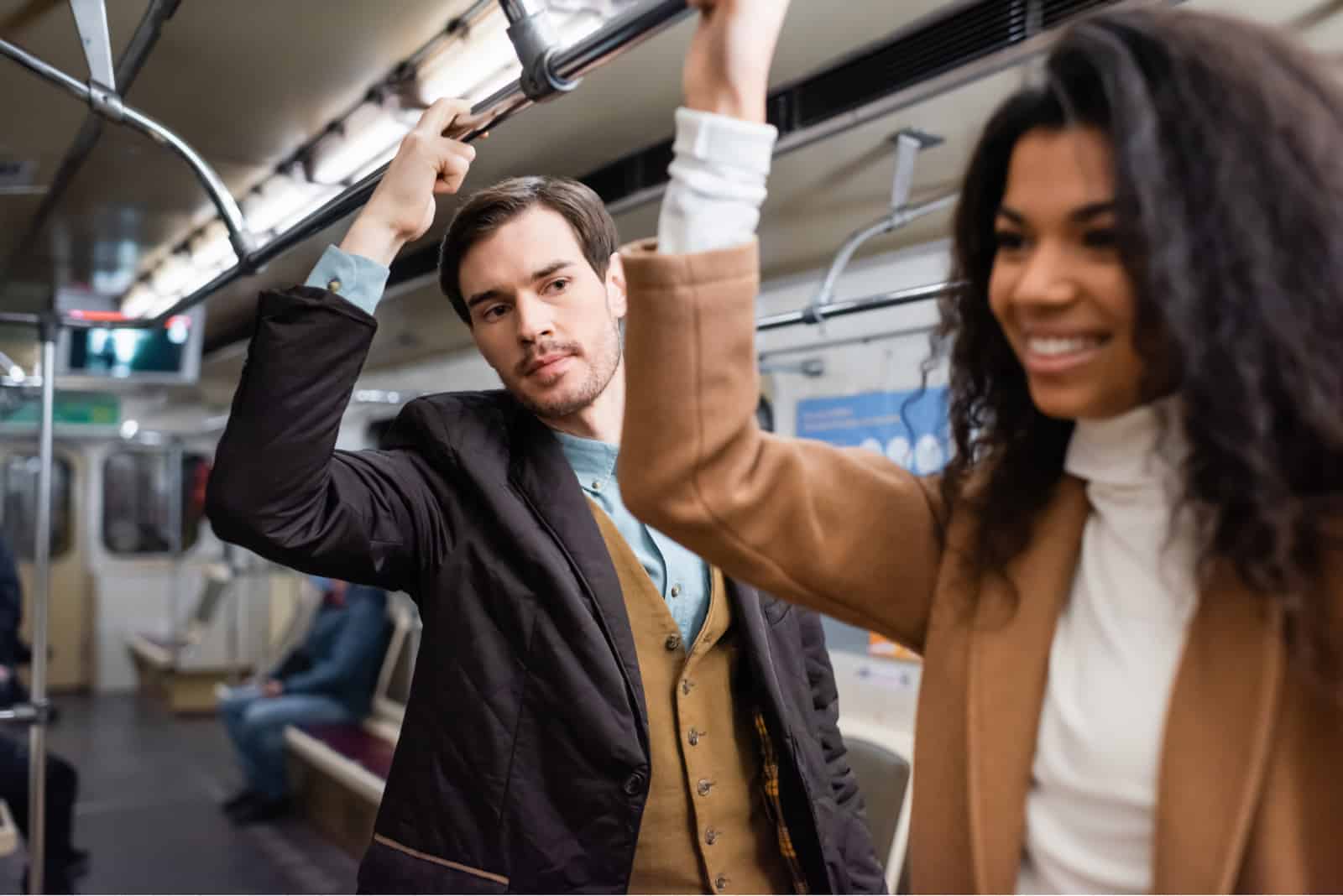 man looking at woman in train