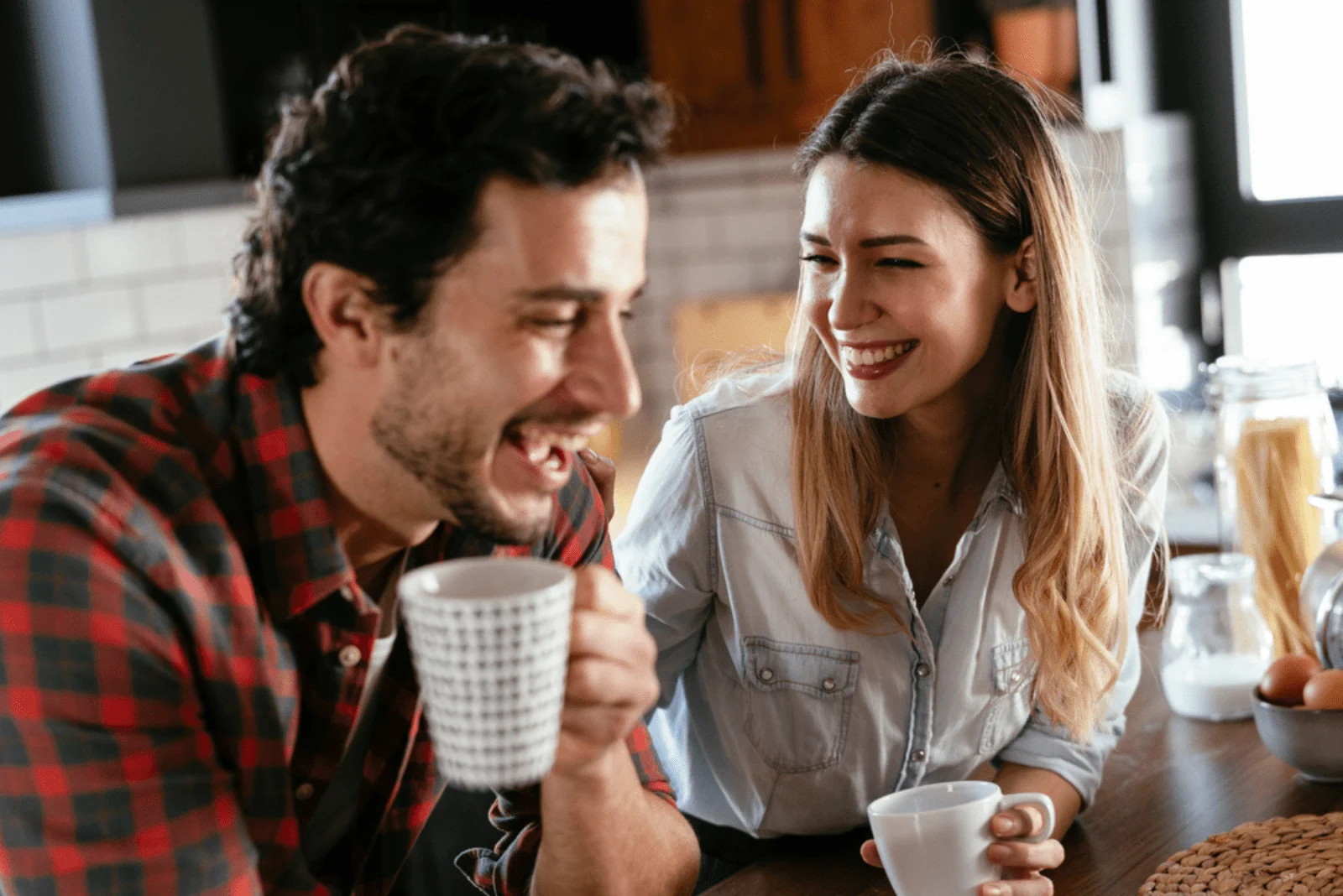 smiling man and woman sitting in a cafe