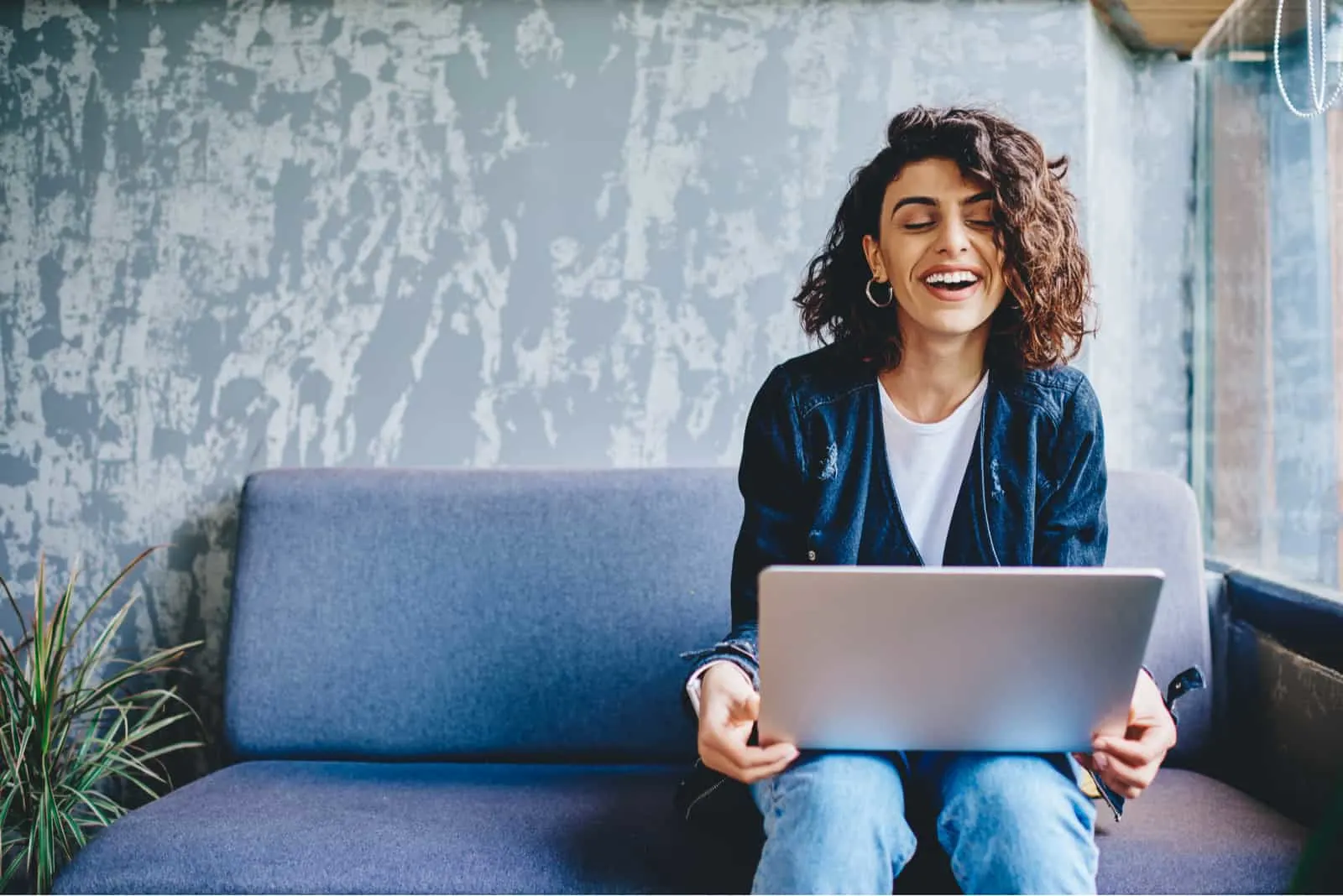 stylish female smiling while using laptop
