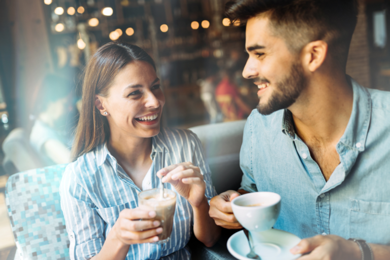 a smiling woman sits next to a man