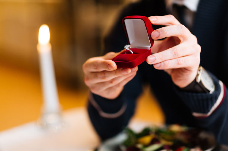 man holding an engagement ring