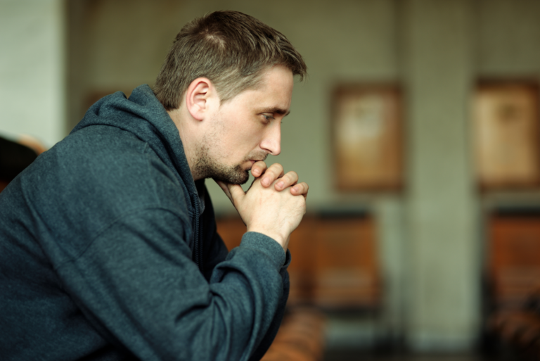 pensive man sits