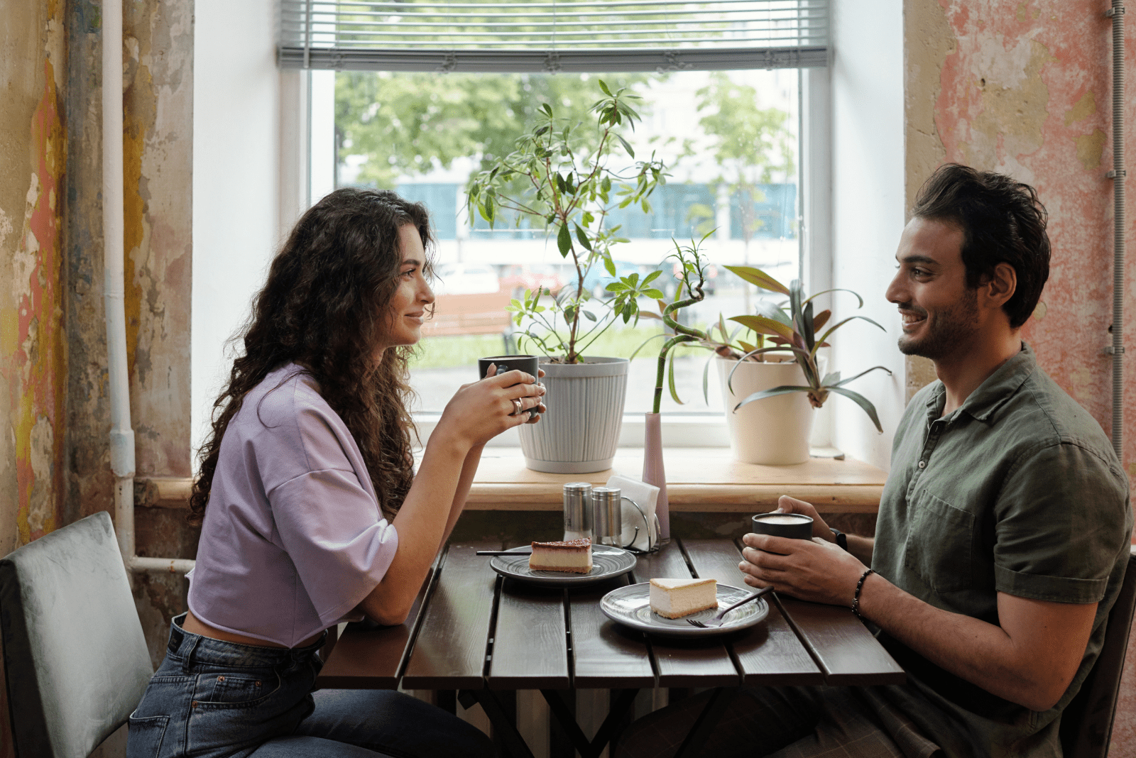 A handsome man and woman are sitting in a cafe