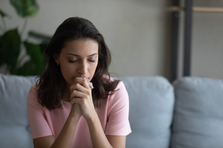 sad woman sitting on sofa
