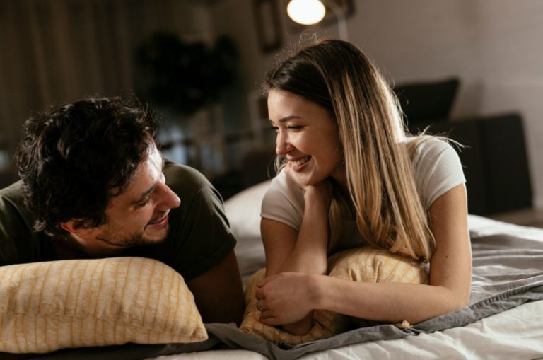happy couple laying on the bed