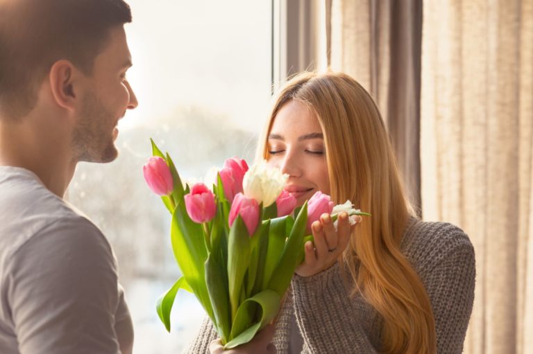 man giving flowers to his girlfriend