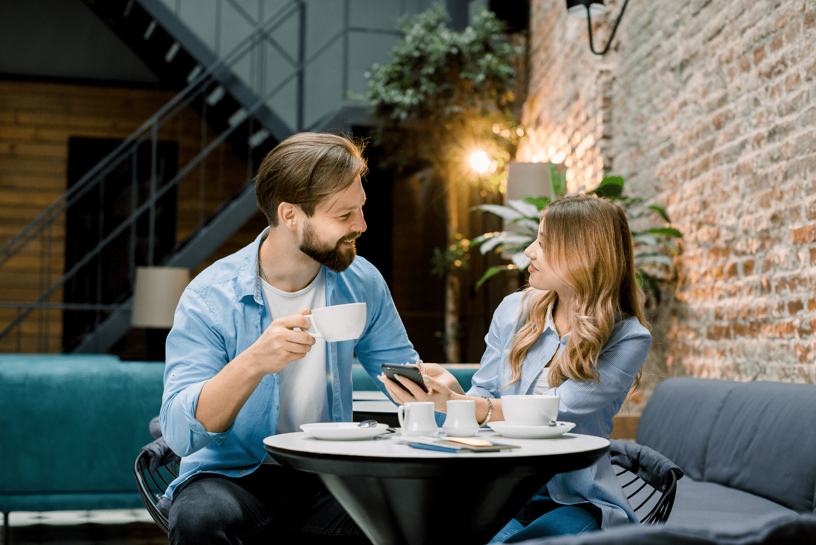 a man and a woman are sitting in a cafe