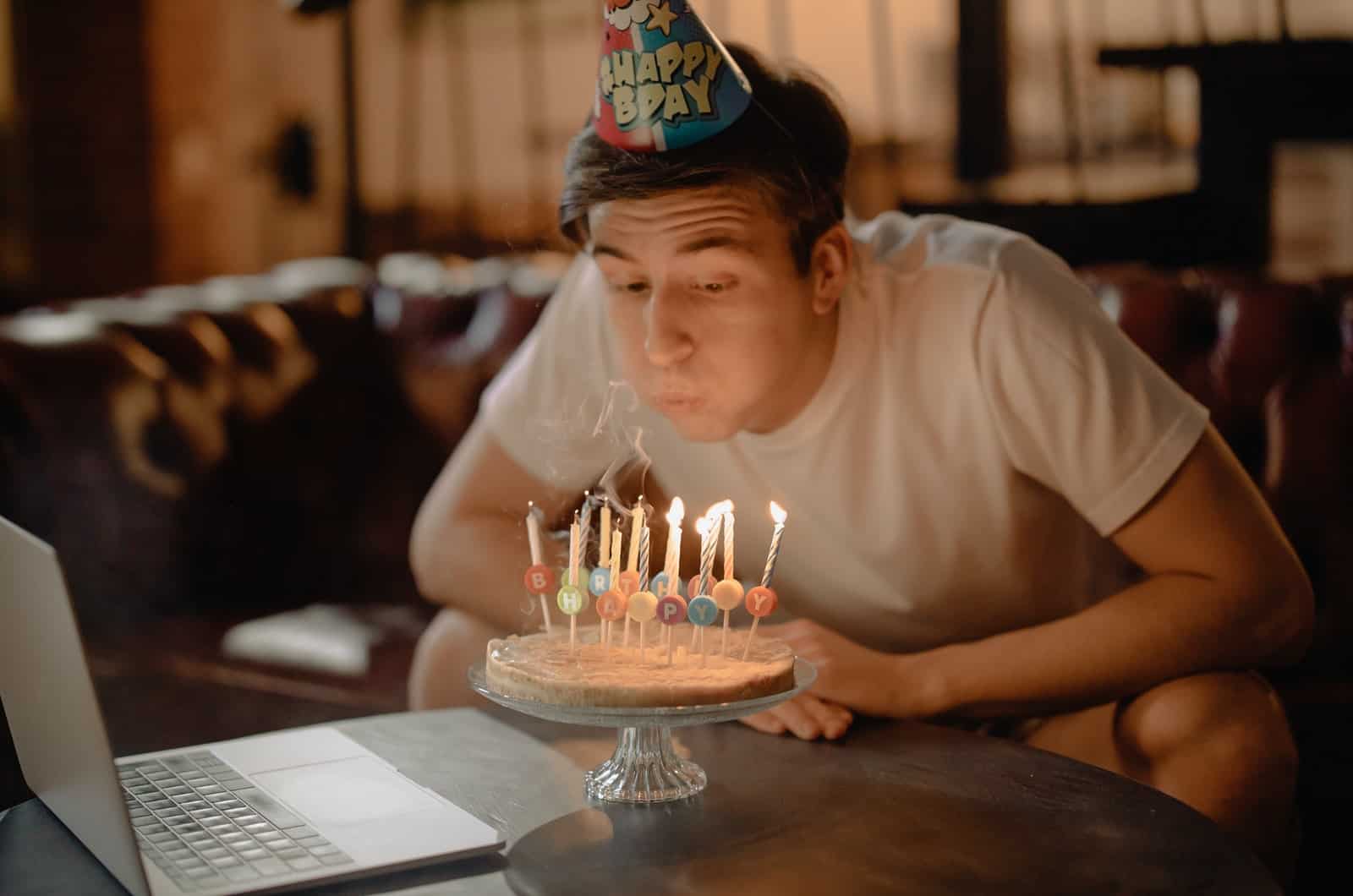 man blowing out candles