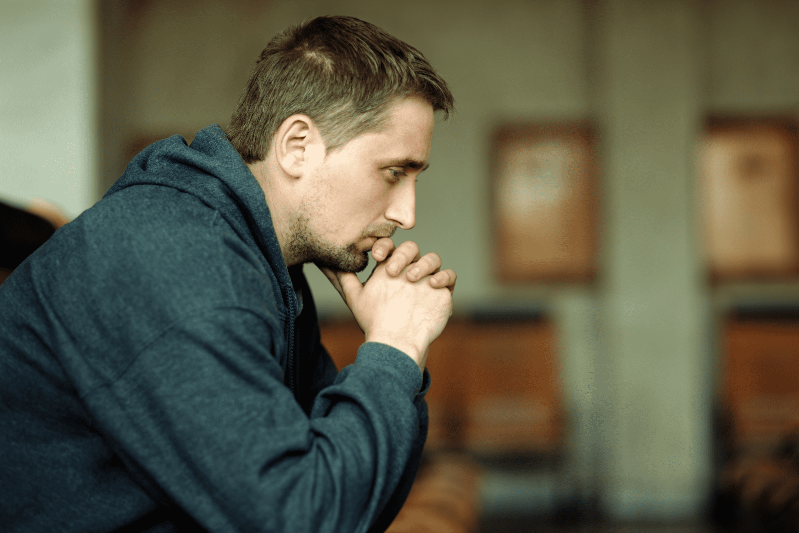 pensive man sitting on the couch