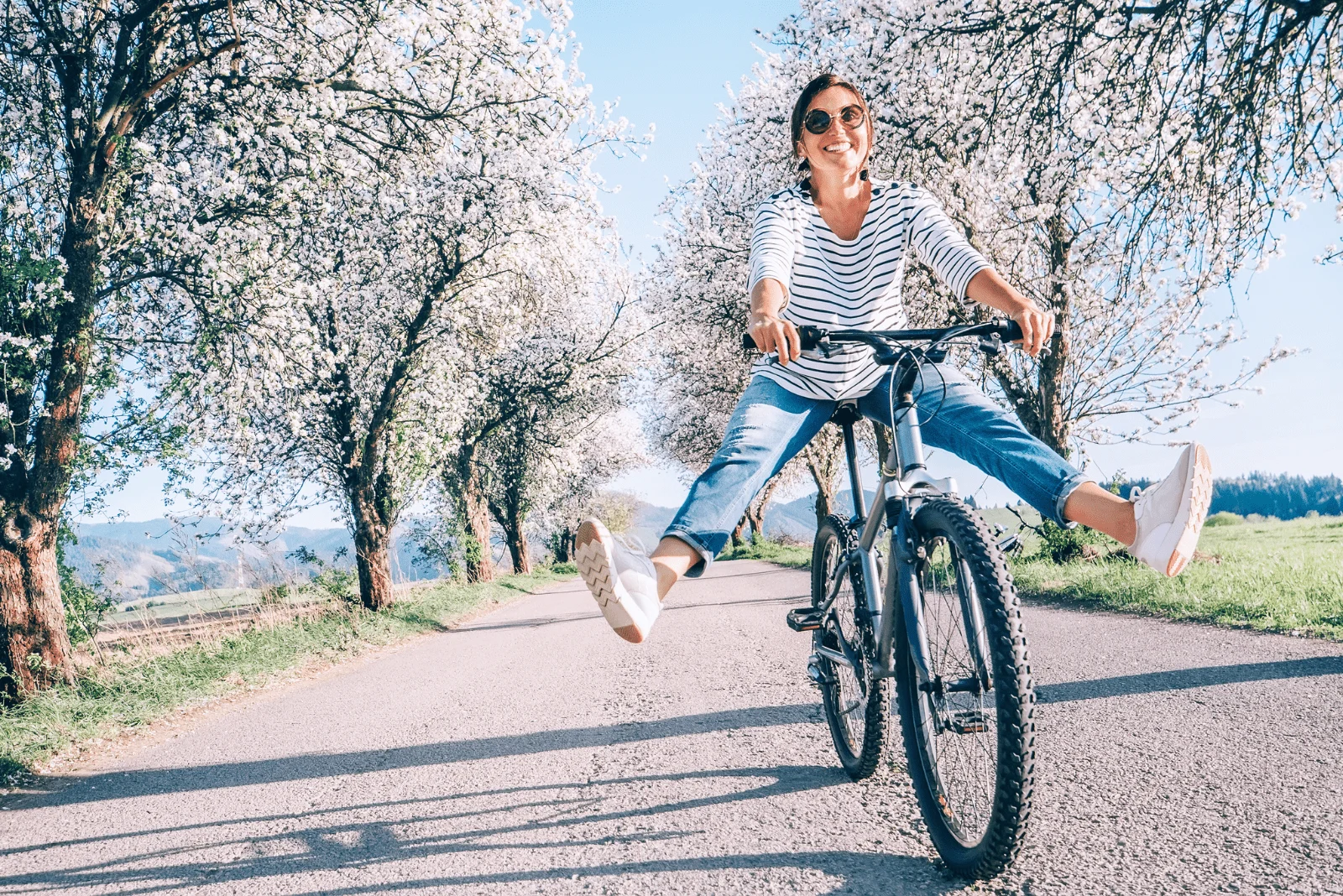 smiling woman on a bicycle