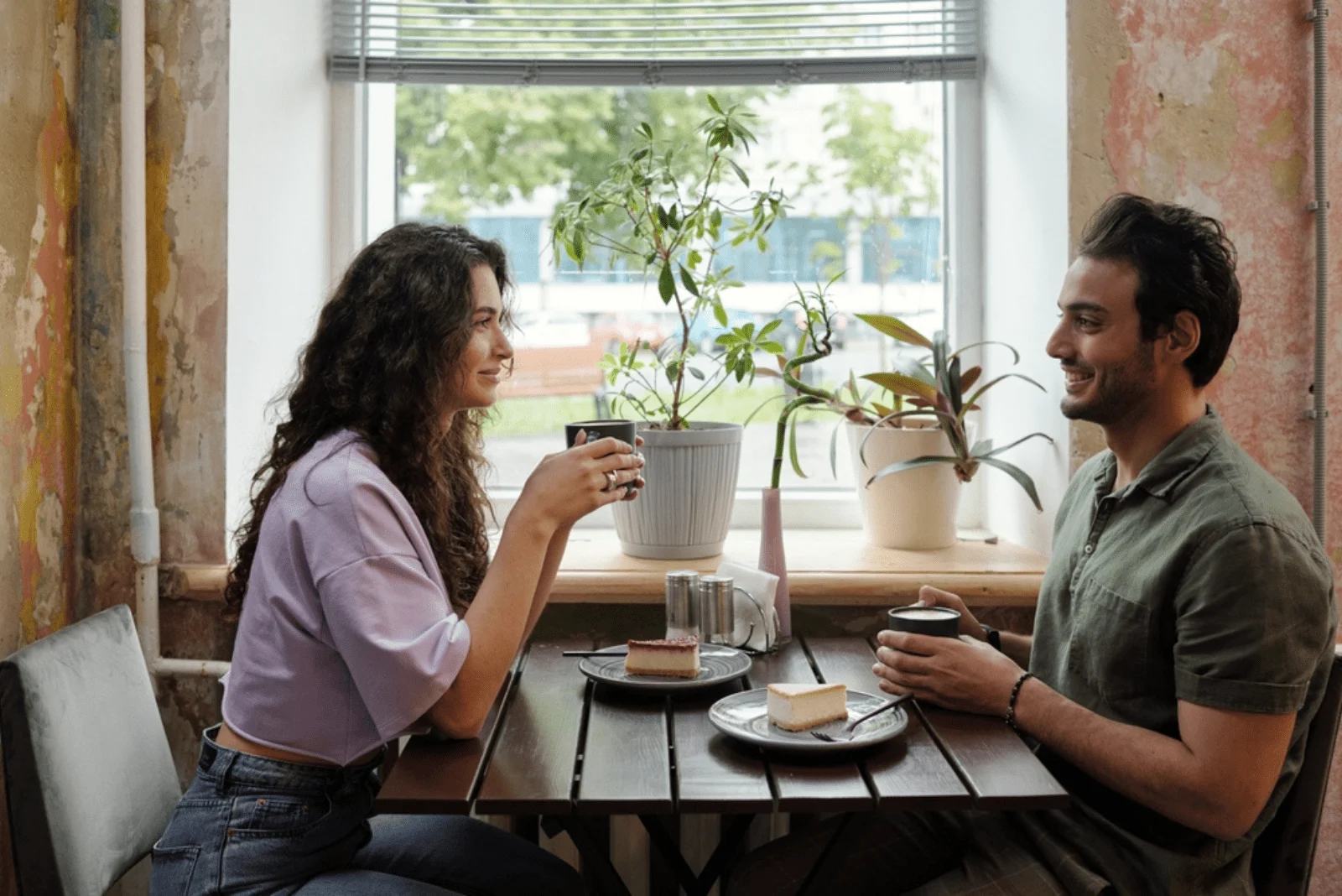 A smiling man and woman are sitting in a restaurant