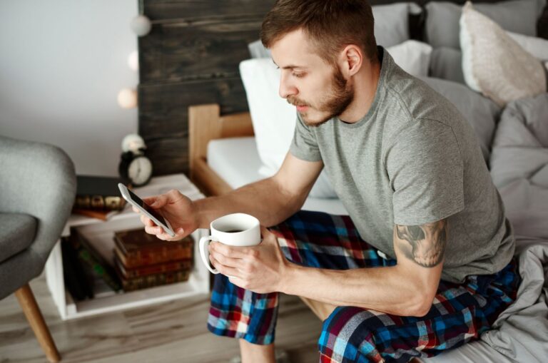 guy sending good morning texts typing on his phone