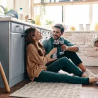couple sitting on floor and having a fun conversation