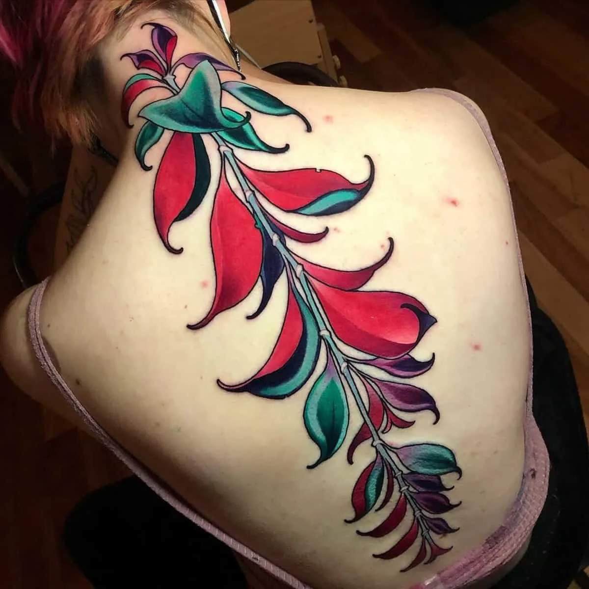  Floral green and red spine tattoo