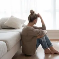 disappointed woman sitting on the floor