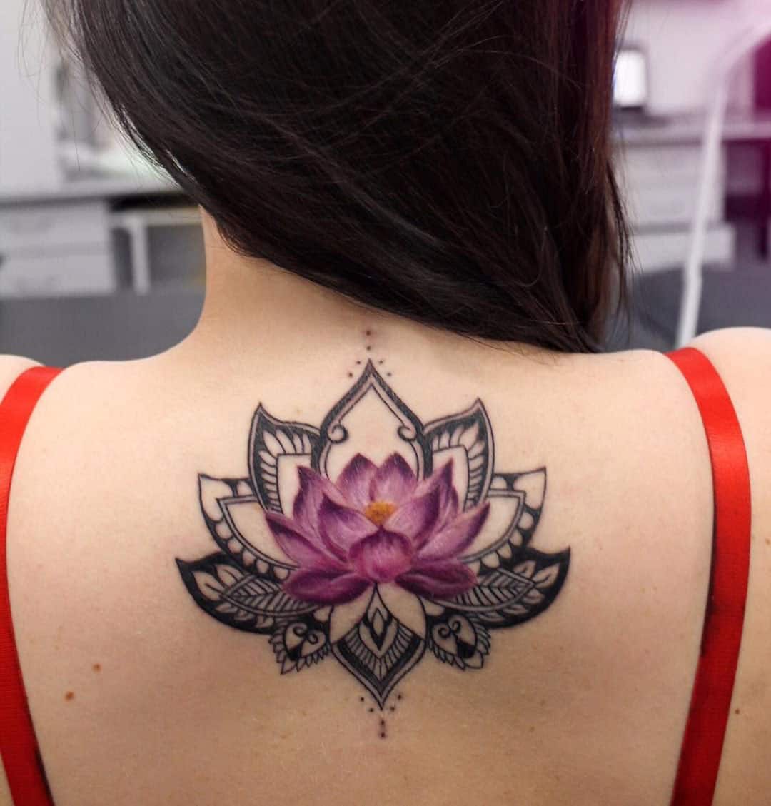 Lotus flower upper-back tattoo
