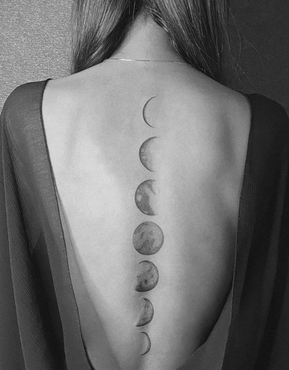 Moon phases spine tattoo